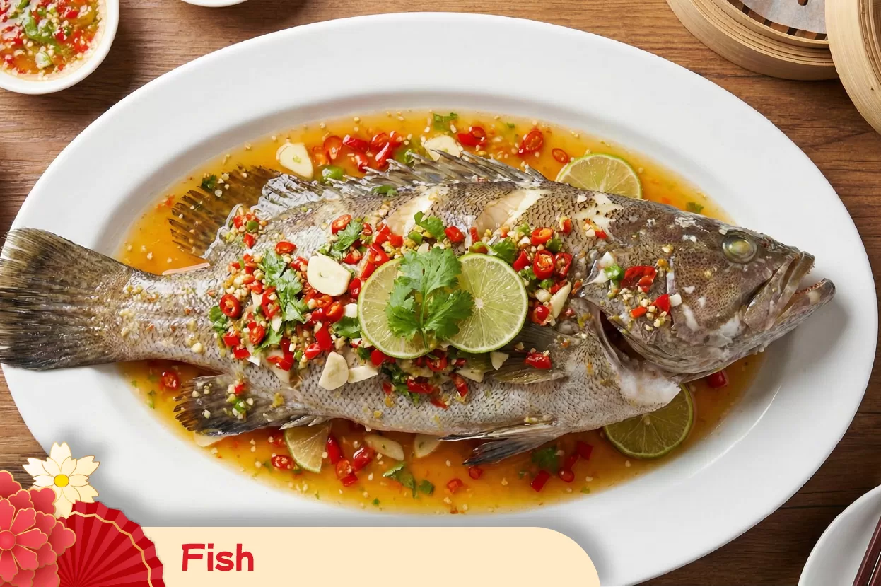 Serving steamed fish as a traditional Chinese New Year symbol of abundance and surplus for a prosperous year ahead
